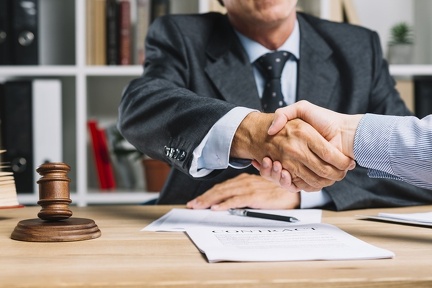 lawyer-his-client-shaking-hands-together-desk