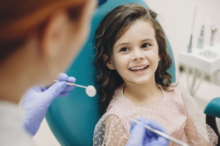 lovely-little-kid-smiling-while-talking-with-pediatric-dentist-after-doing-tenth-examination-pediatric-stomatology