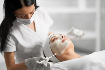 beautician-applying-special-white-cream-patient