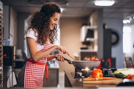 woman-chef-cooking-vegetables-pan
