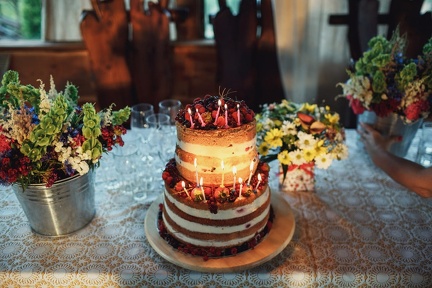 tired-cake-made-white-cream-berries-with-burning-candles