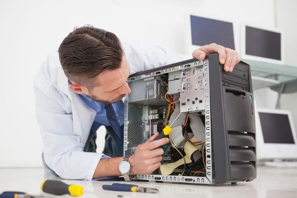 computer-engineer-working-broken-console-with-screwdriver