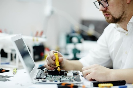man-assembling-circuit-board-laptop