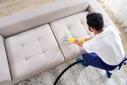 close-up-housekeeper-holding-modern-washing-vacuum-cleaner-cleaning-dirty-sofa-with-professionally-detergent-professional-springclean-home-concept (1)